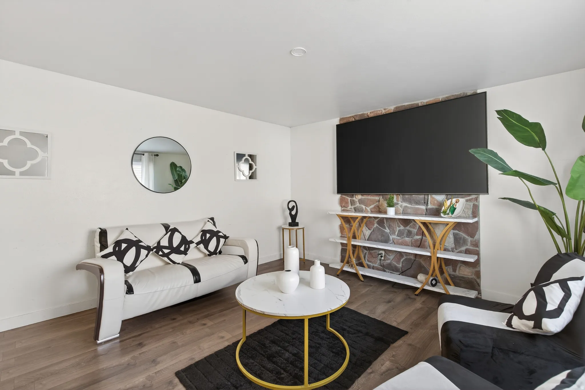 Living area with wood finished floors and baseboards