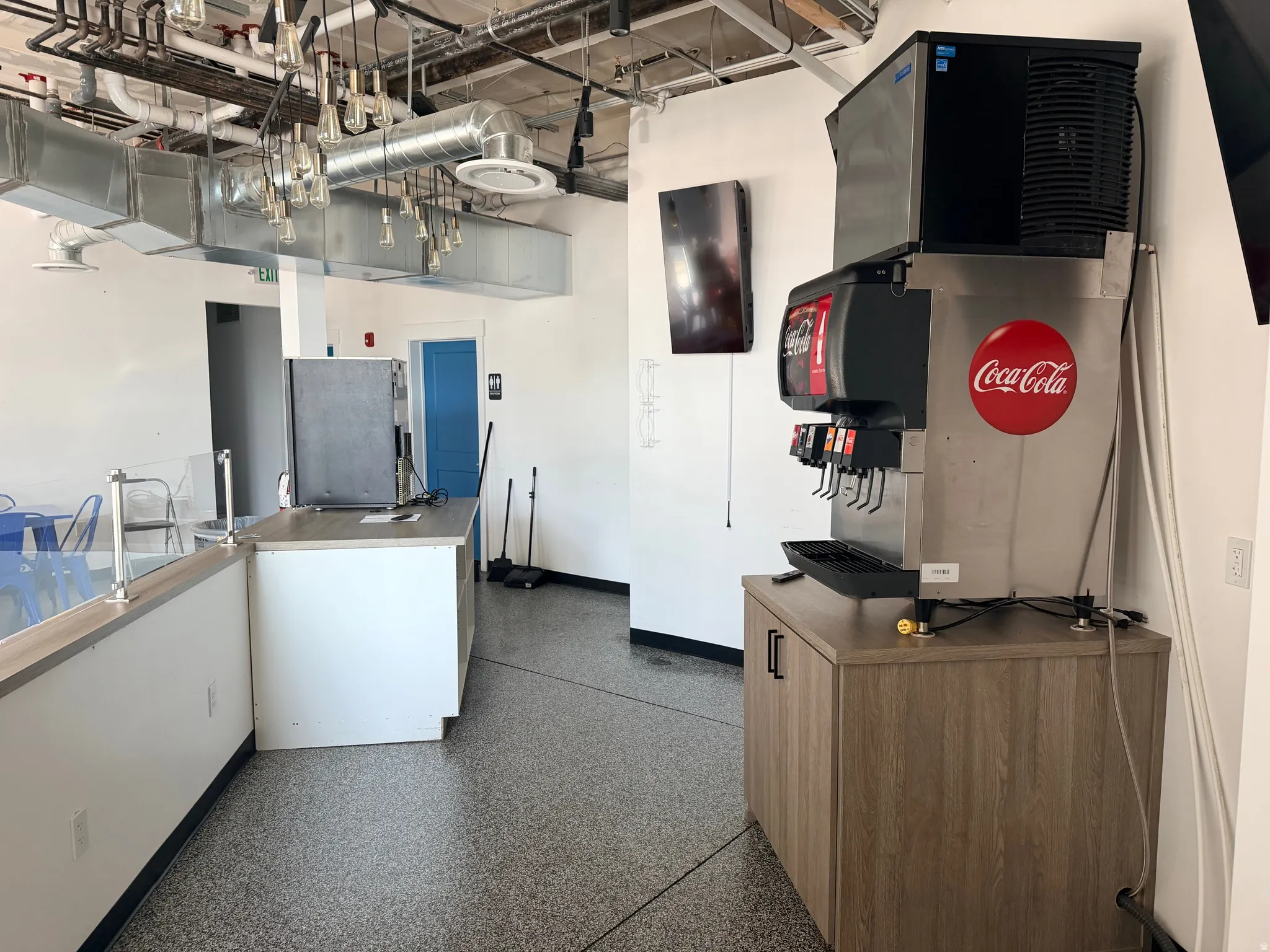 Kitchen featuring a towering ceiling and freestanding refrigerator