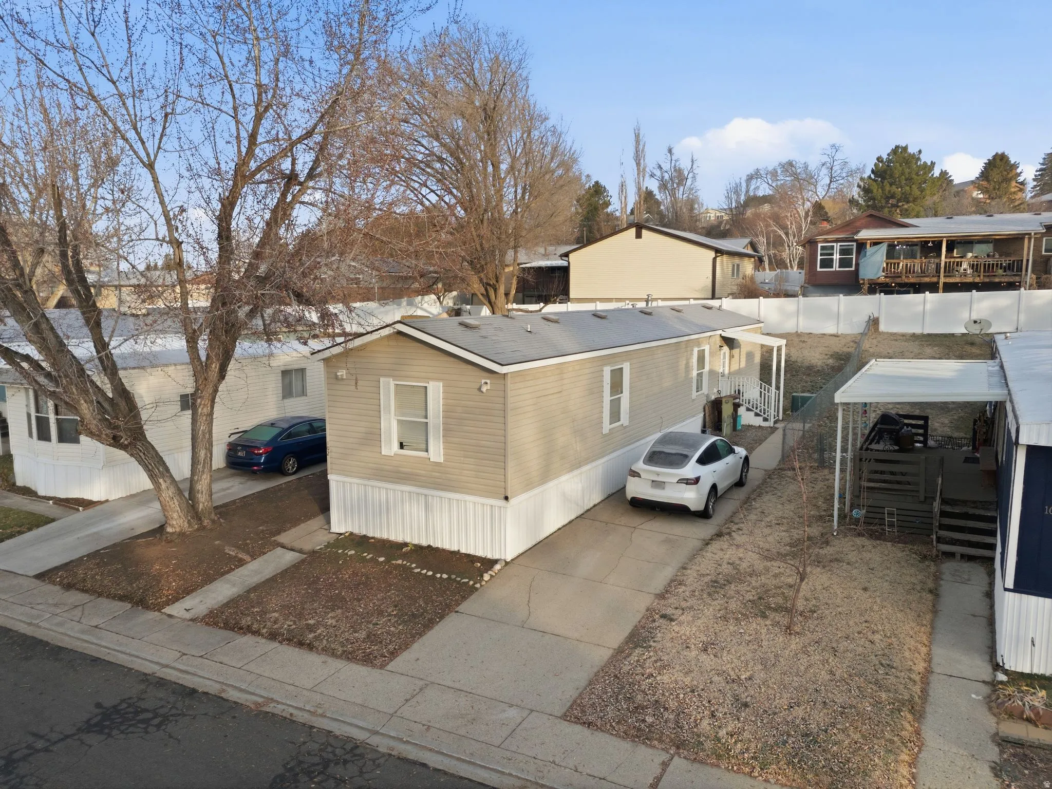 View of side of home featuring a residential view and concrete driveway