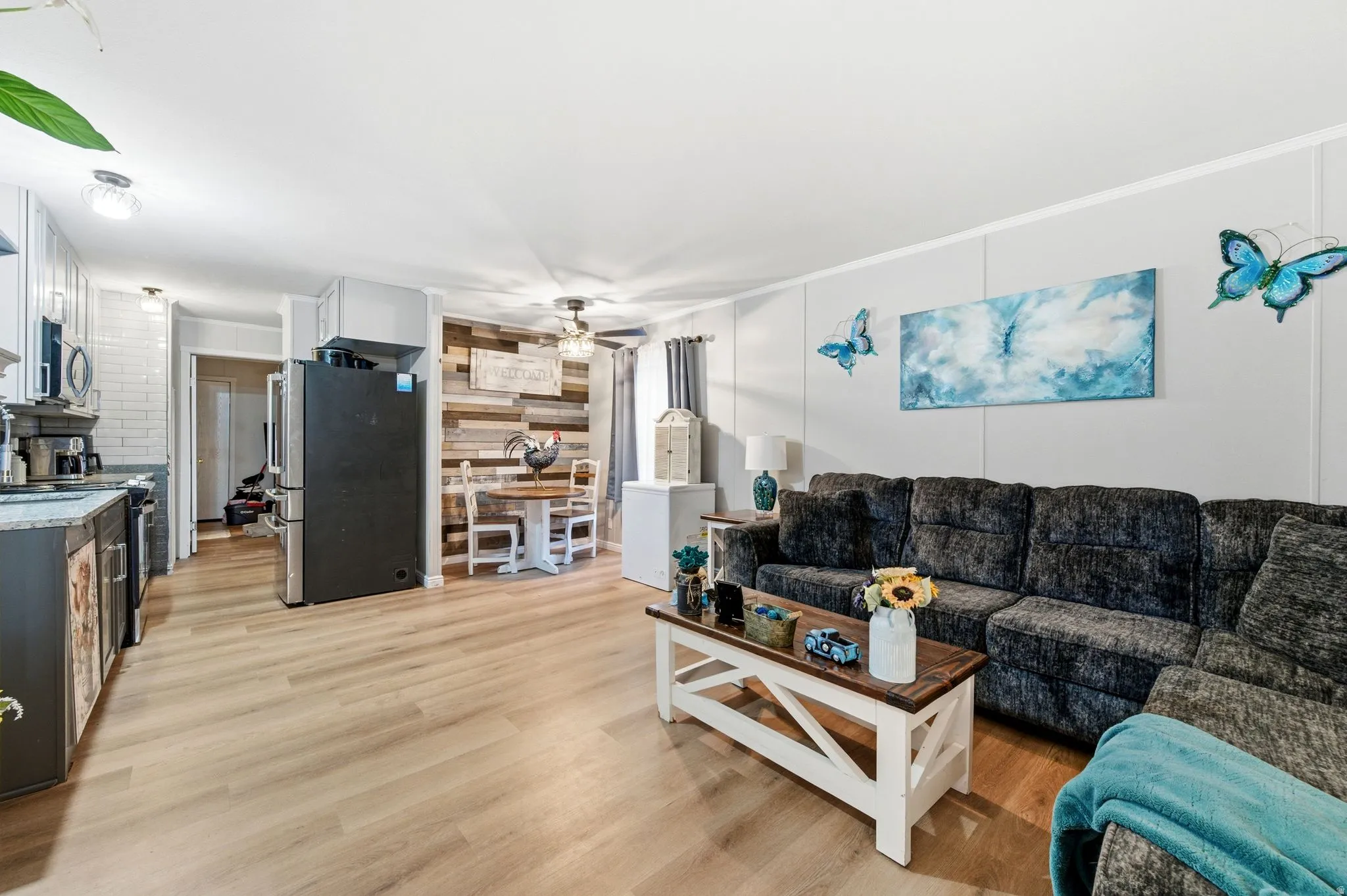 Living room featuring light wood-type flooring and ceiling fan
