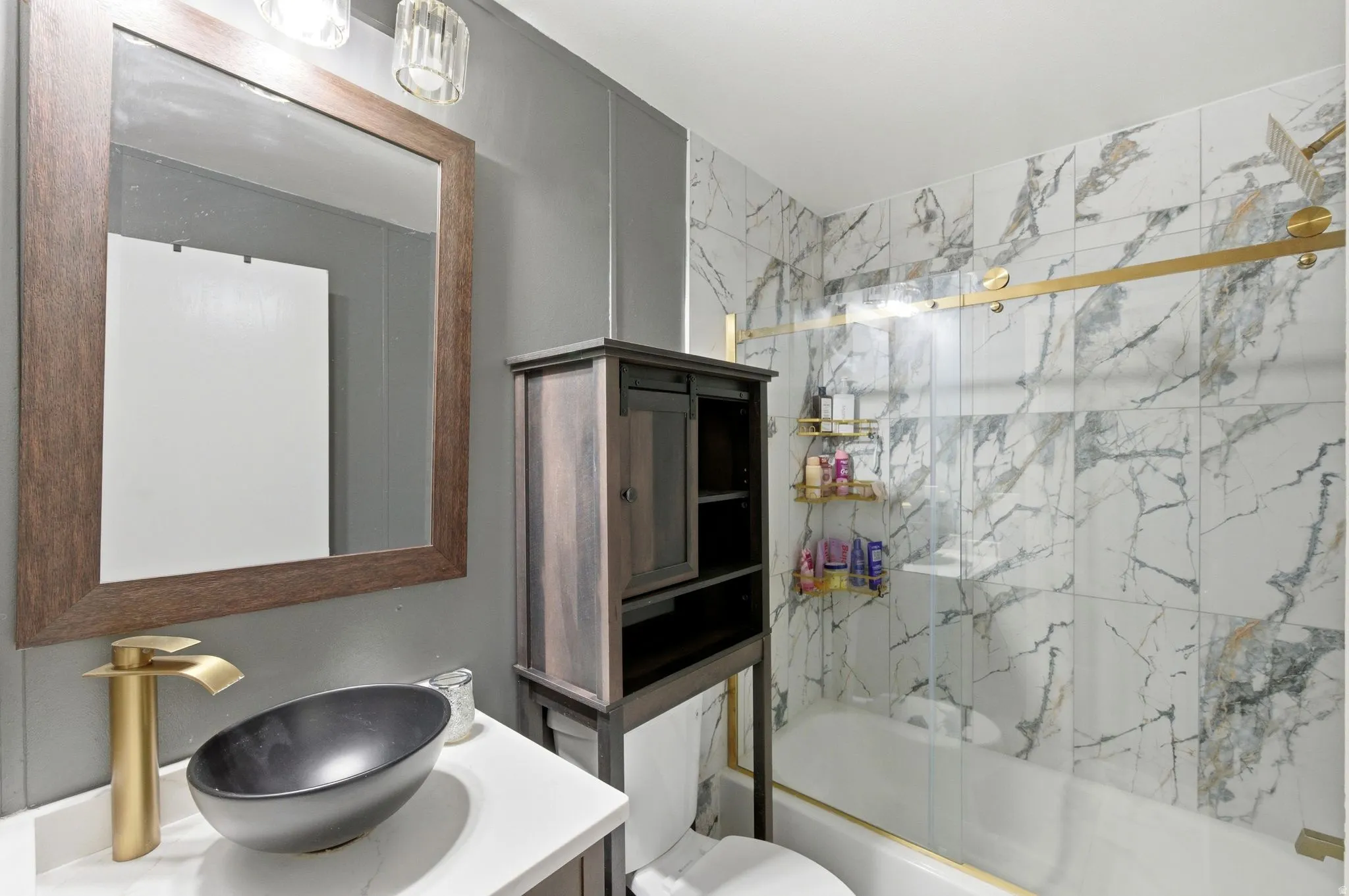 Bathroom with shower / bath combination with glass door and vanity