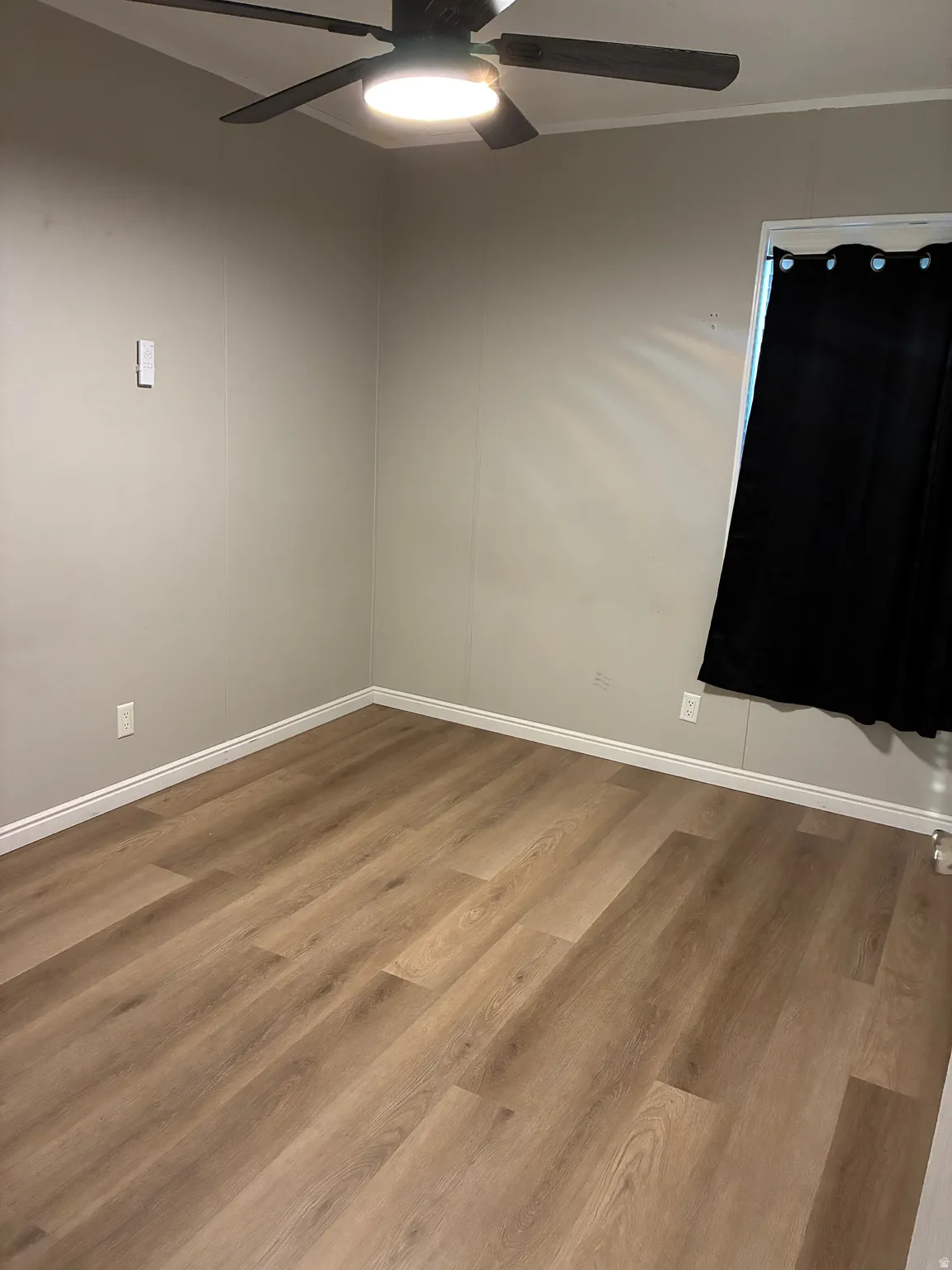 Empty room featuring wood finished floors and ceiling fan