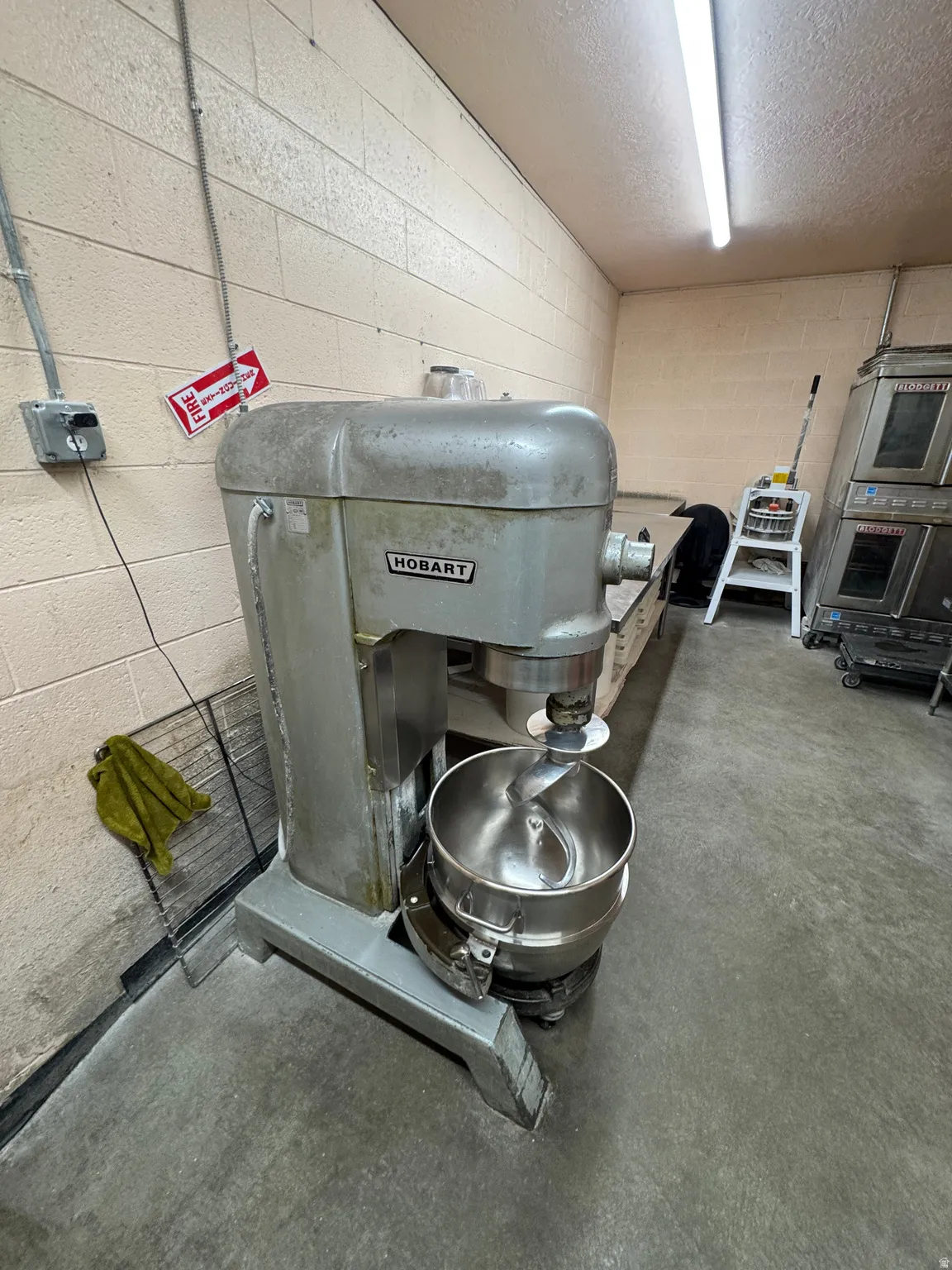 Detailed view of concrete block wall, concrete floors, and a textured ceiling