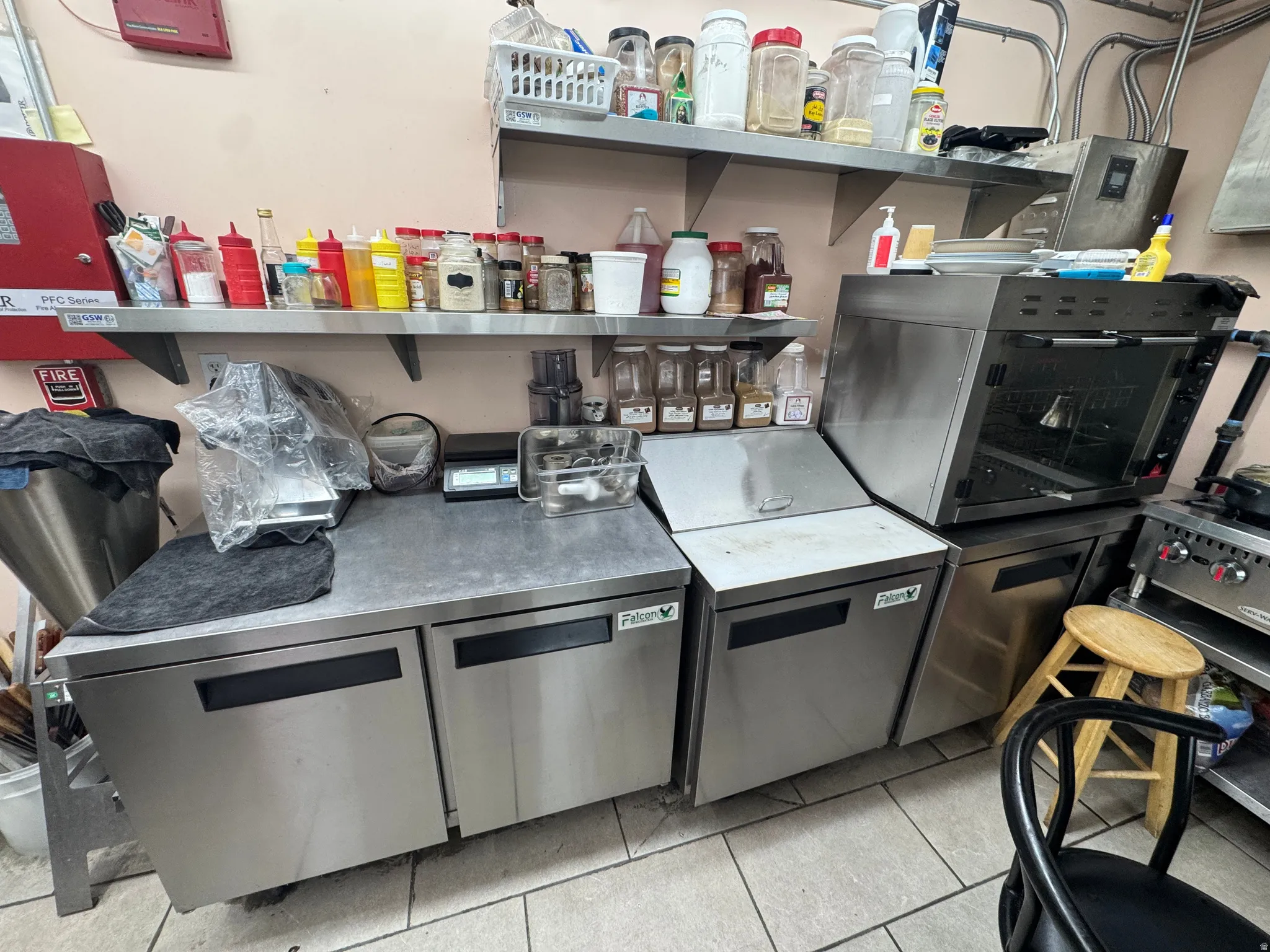 Kitchen featuring stainless steel dishwasher and light tile patterned floors