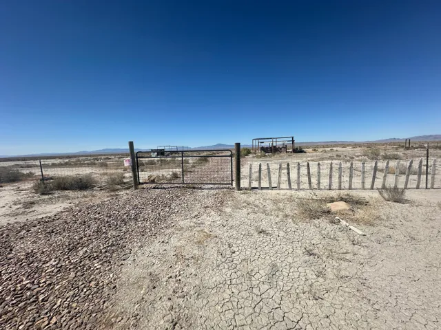 Gate with a mountain view and a view of rural / pastoral area