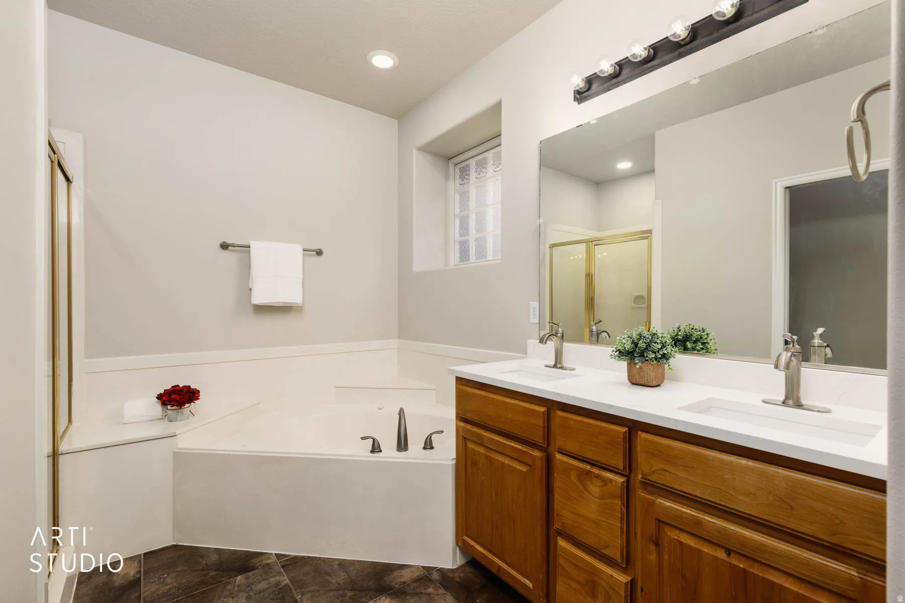 Full bath with a bath, double vanity, and a shower stall