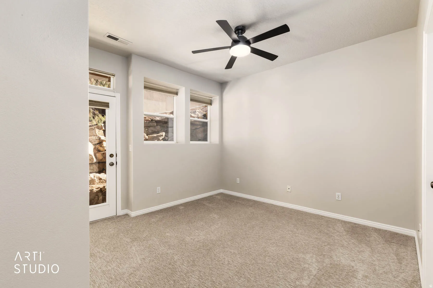 Unfurnished room featuring a ceiling fan and light carpet