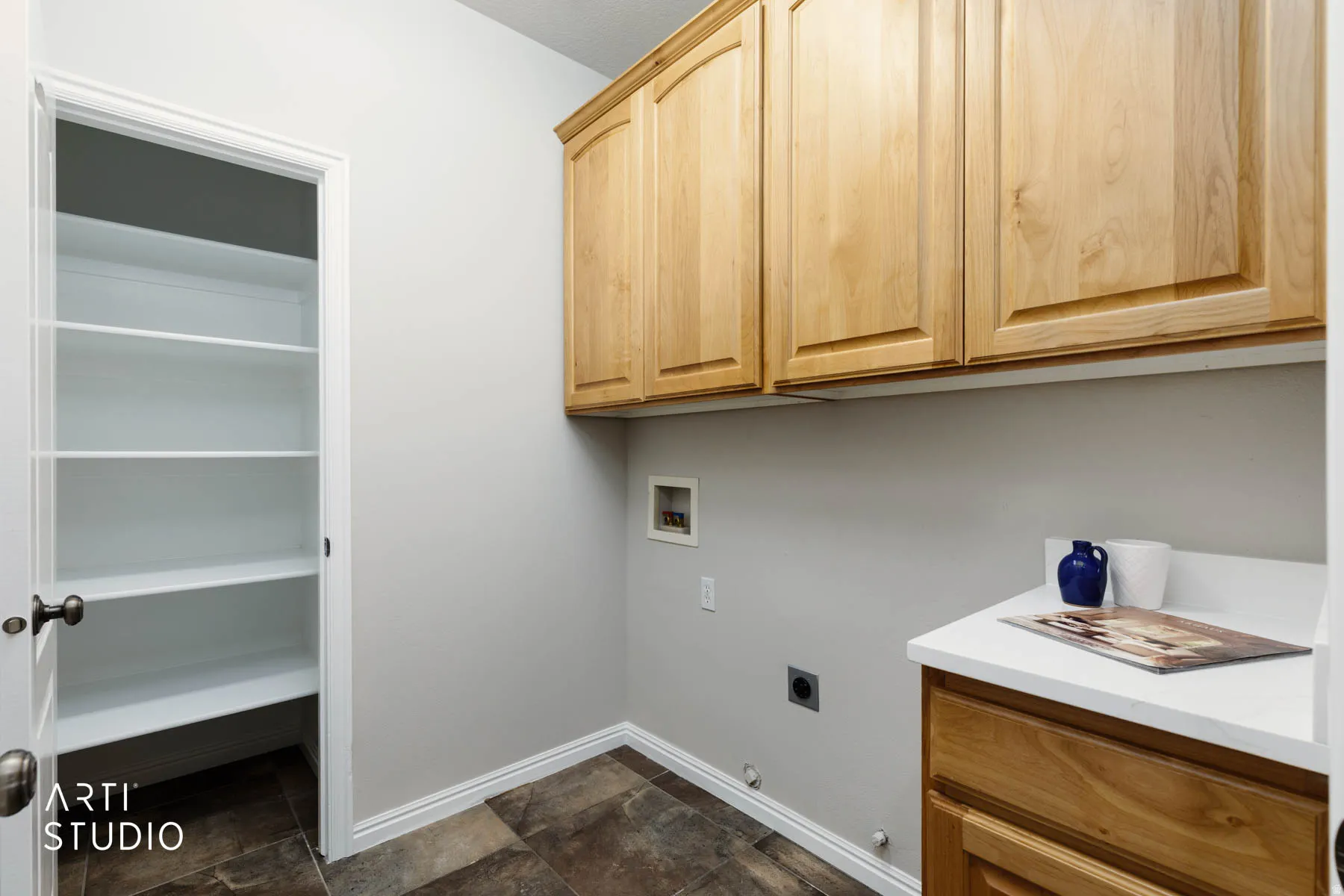 Washroom featuring washer hookup, gas dryer hookup, hookup for an electric dryer, stone finish flooring, and cabinet space