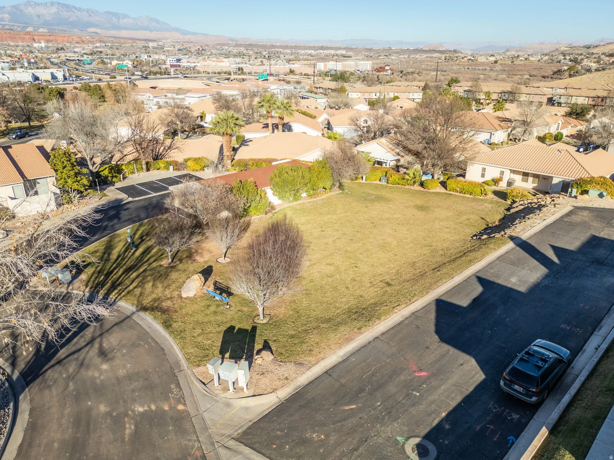 Aerial view of residential area featuring a mountainous background
