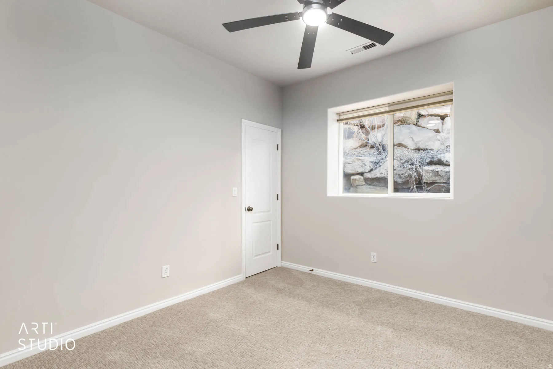 Carpeted spare room with baseboards and a ceiling fan