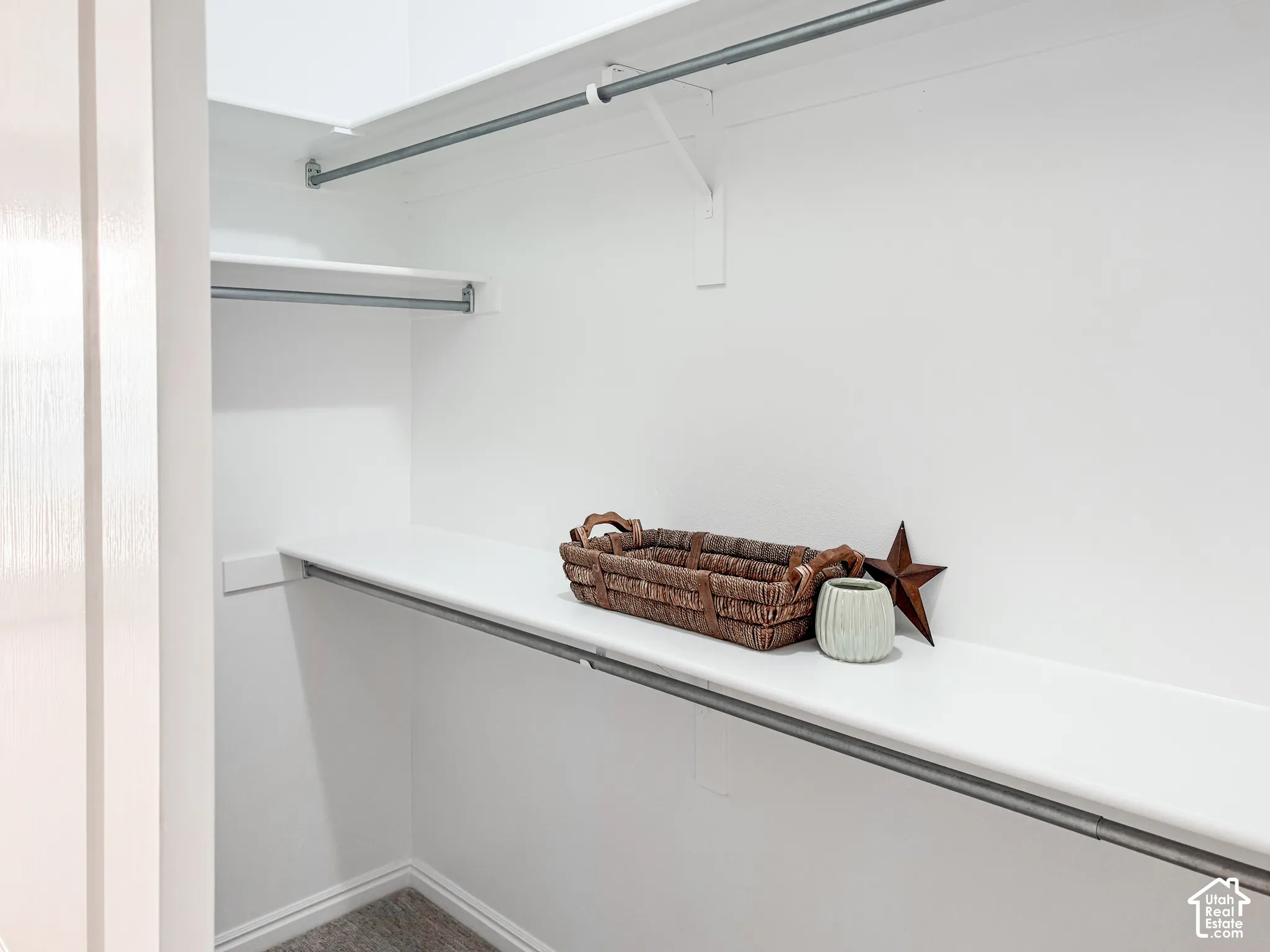 White closet system featuring multiple shelves and hanging rods
