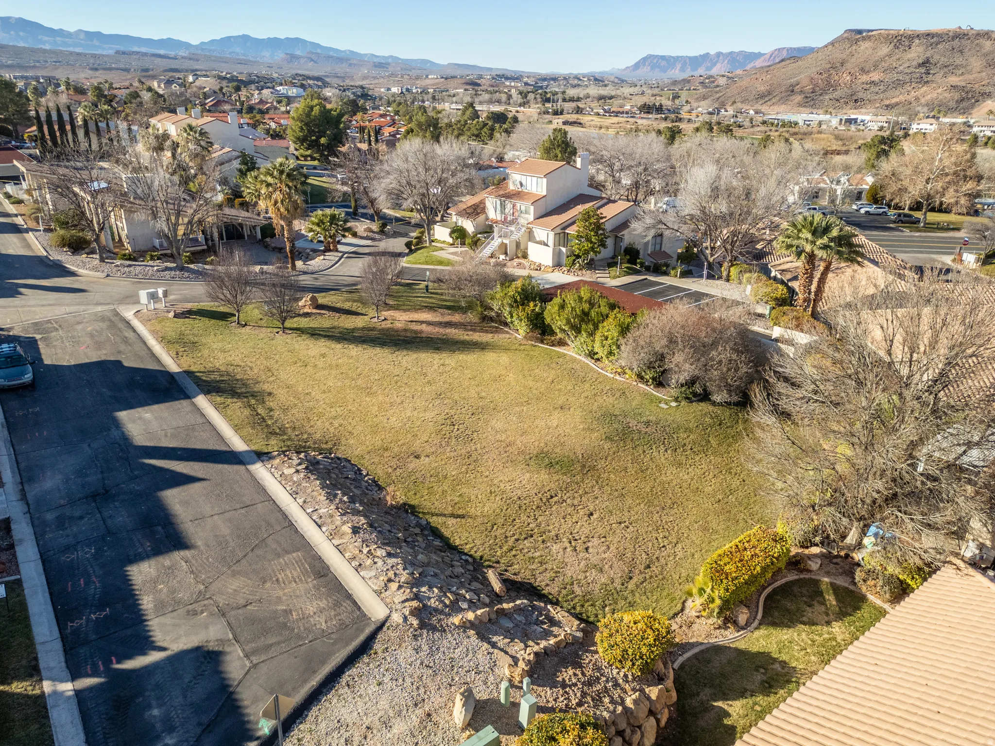 Aerial overview of property's location with mountains and nearby suburban area