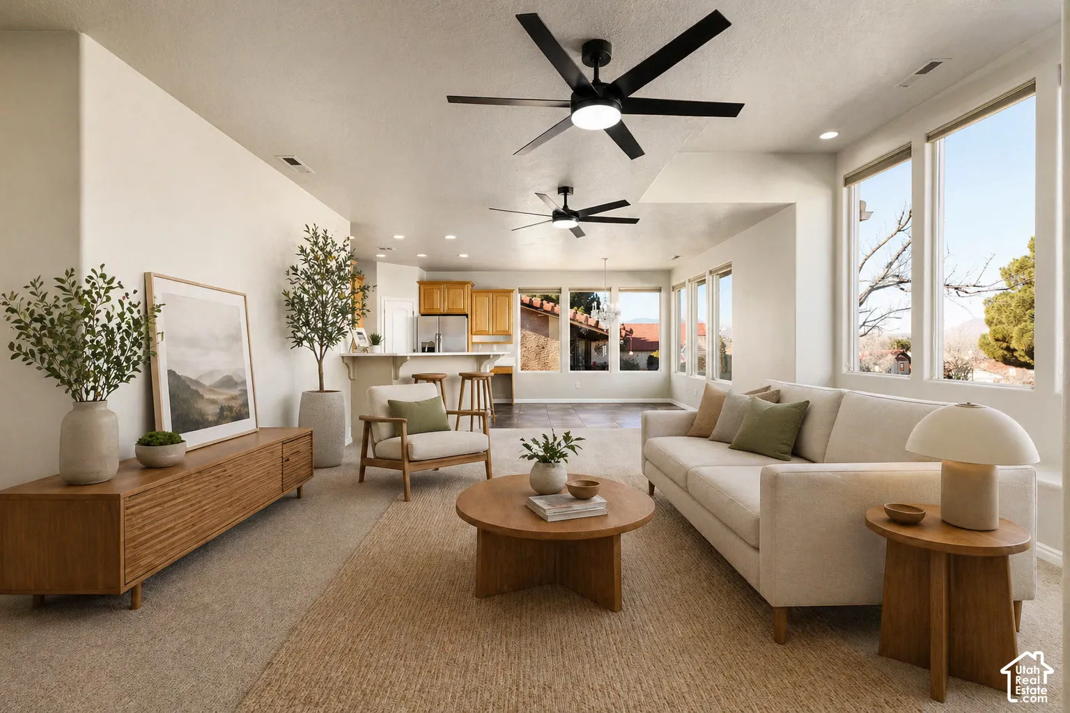 VIRTUALLY Staged. Living area featuring ceiling fan, recessed lighting, and light carpet