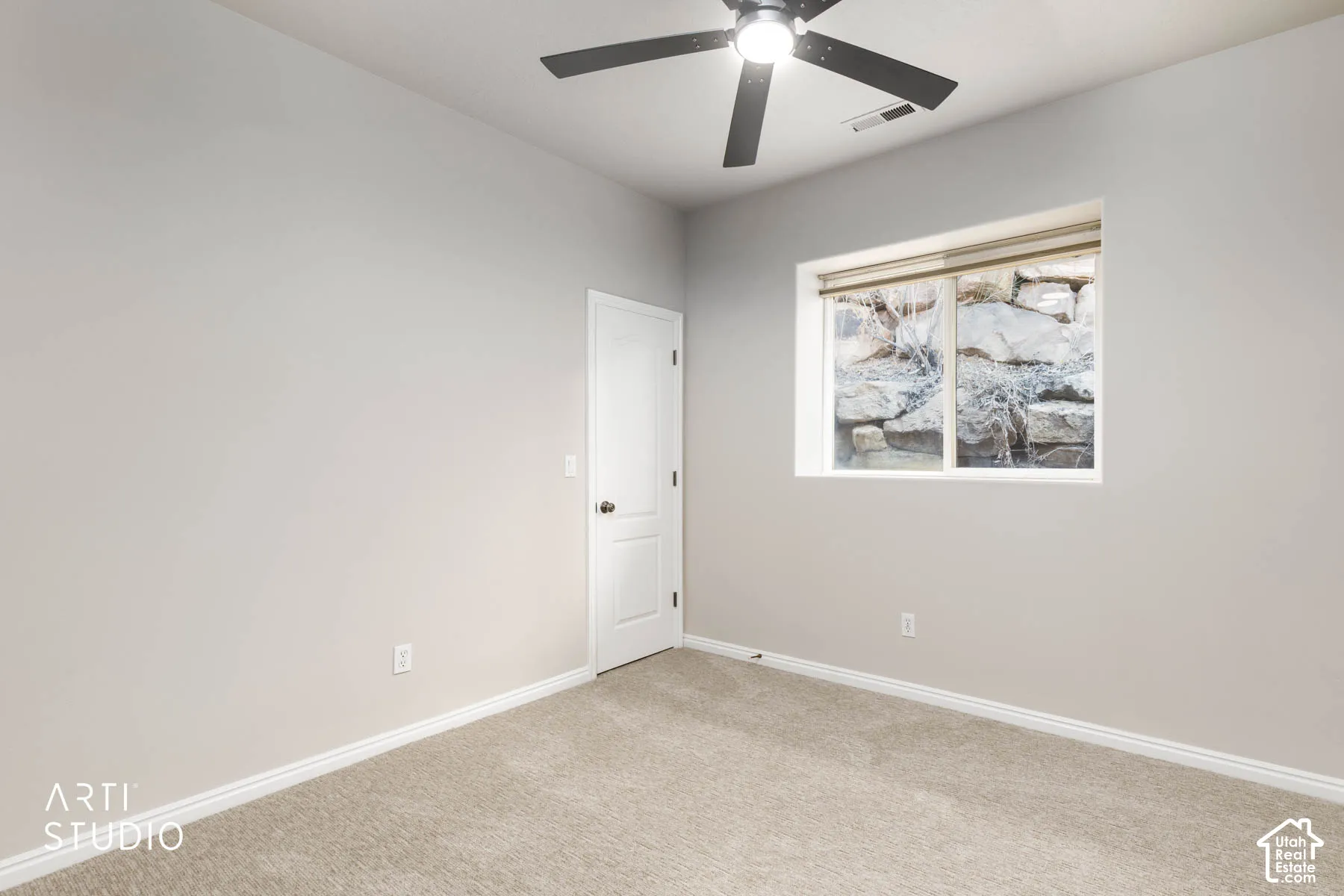 Carpeted spare room with baseboards and a ceiling fan