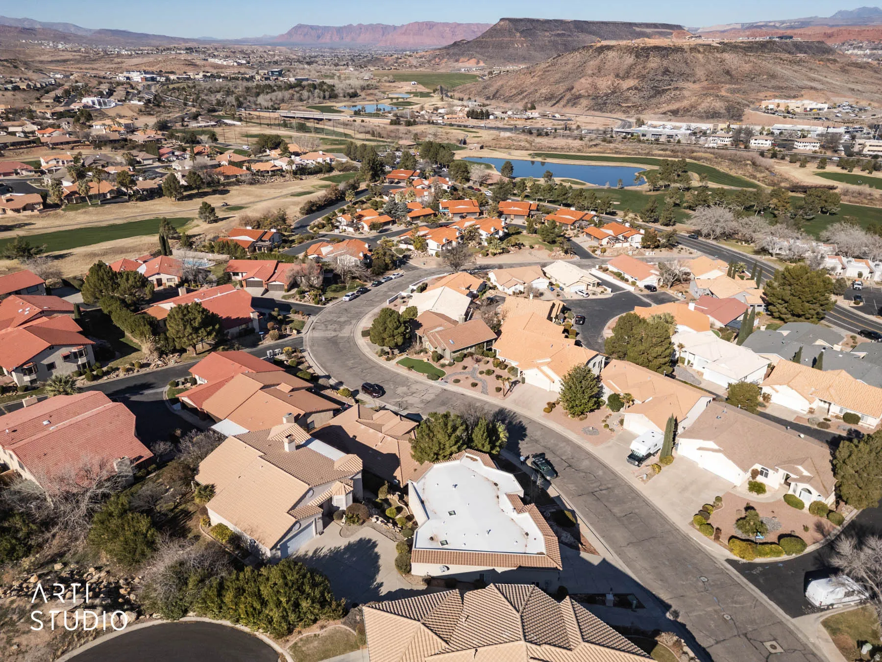 Aerial view of property and surrounding area featuring a water and mountain view and nearby suburban area