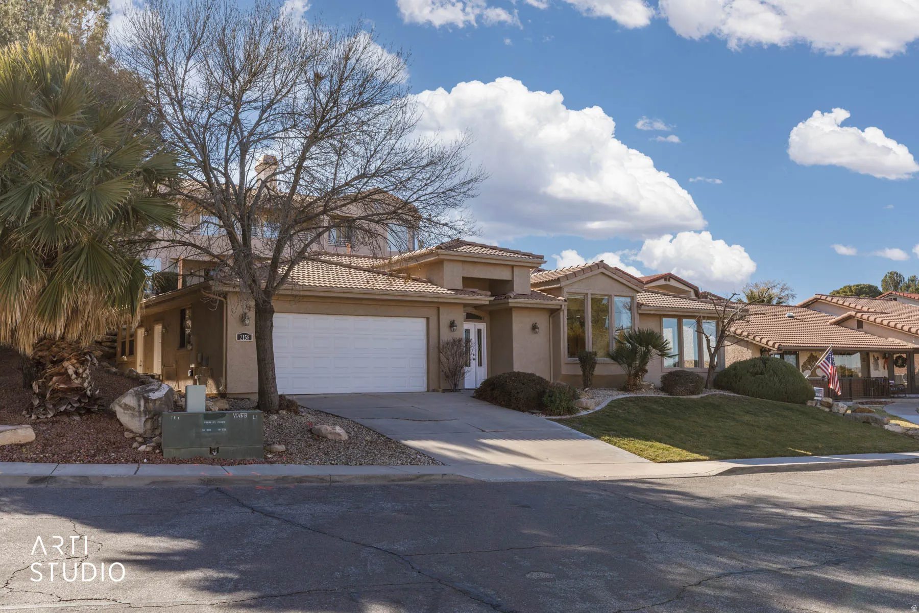 Mediterranean / spanish home featuring stucco siding, concrete driveway, a garage, a tiled roof, and a front yard