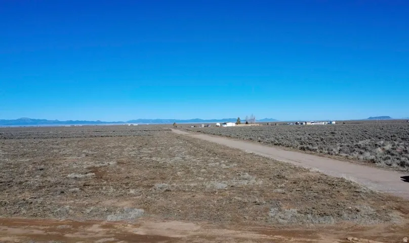 View of dirt / gravel road with a mountain view