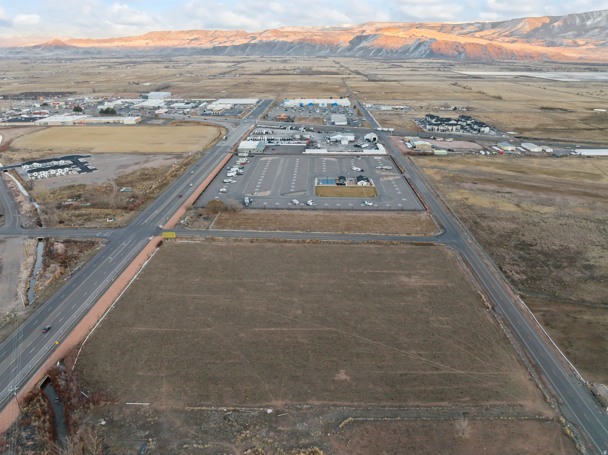 Aerial view of property's location with a mountain backdrop and industrial structures