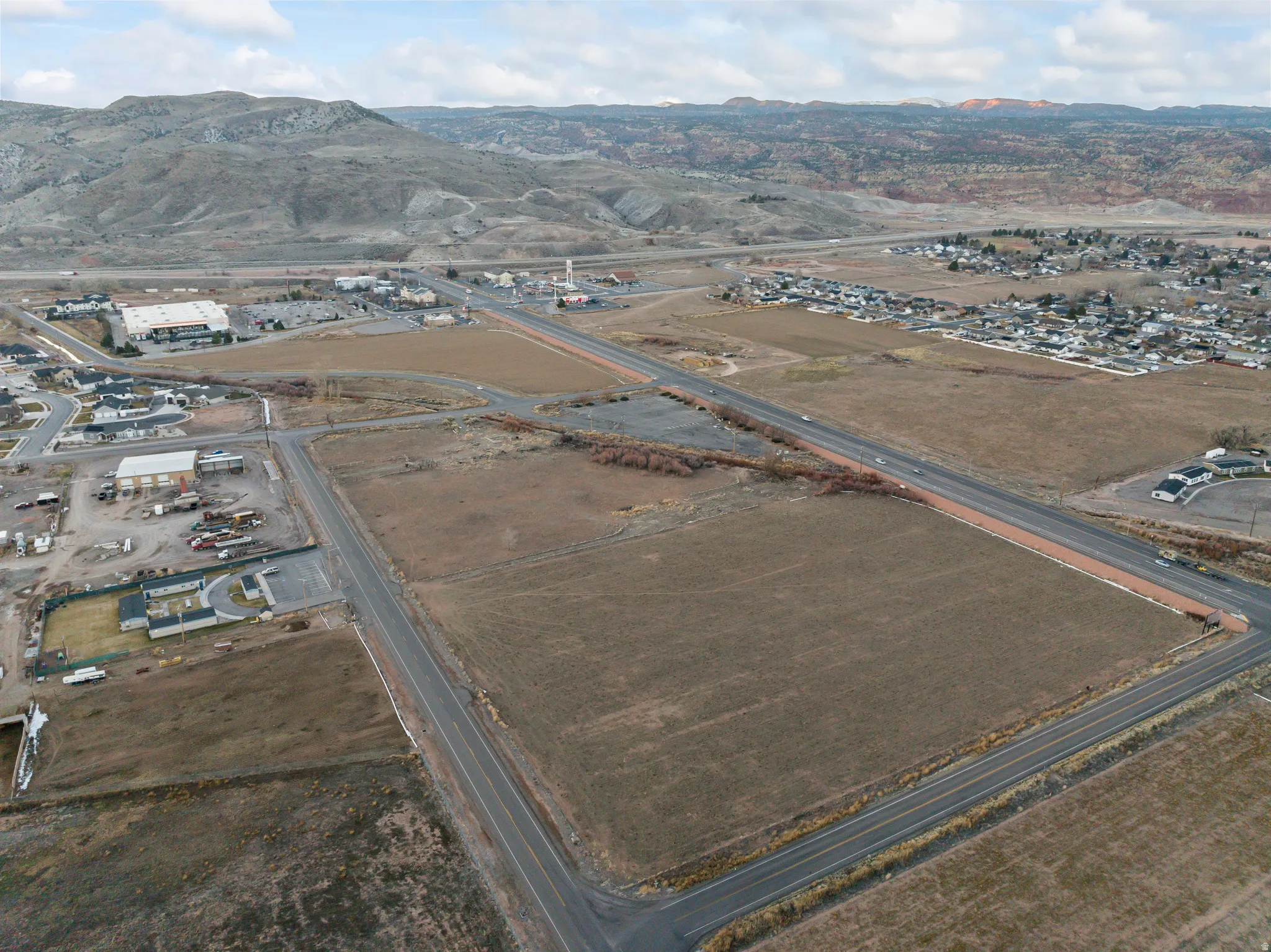 Aerial view of property's location with a mountain backdrop and rural landscape