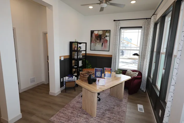 Office with dark wood finished floors, ceiling fan, recessed lighting, and a wainscoted wall