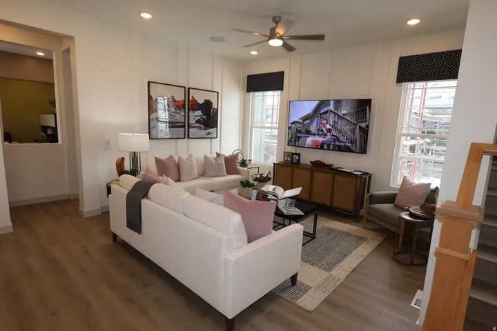 Living area featuring wood finished floors, a ceiling fan, and recessed lighting