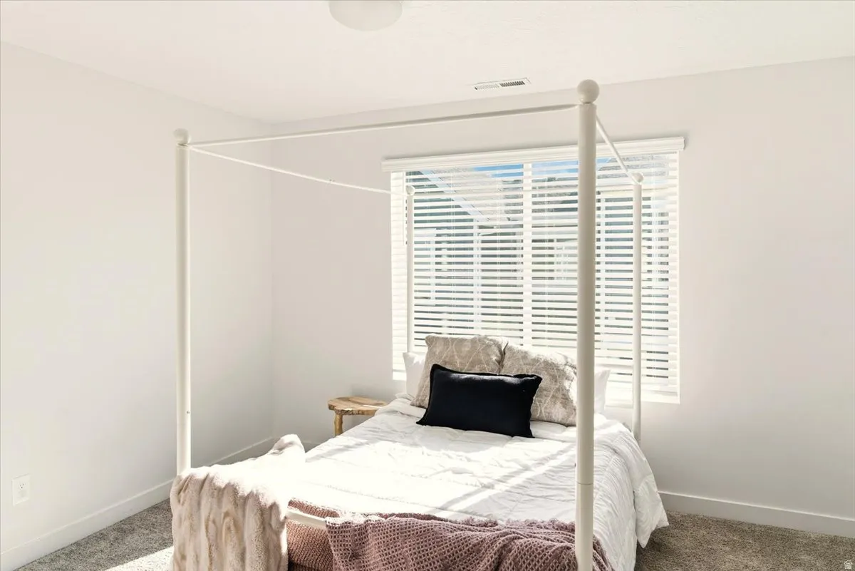 Carpeted bedroom featuring baseboards