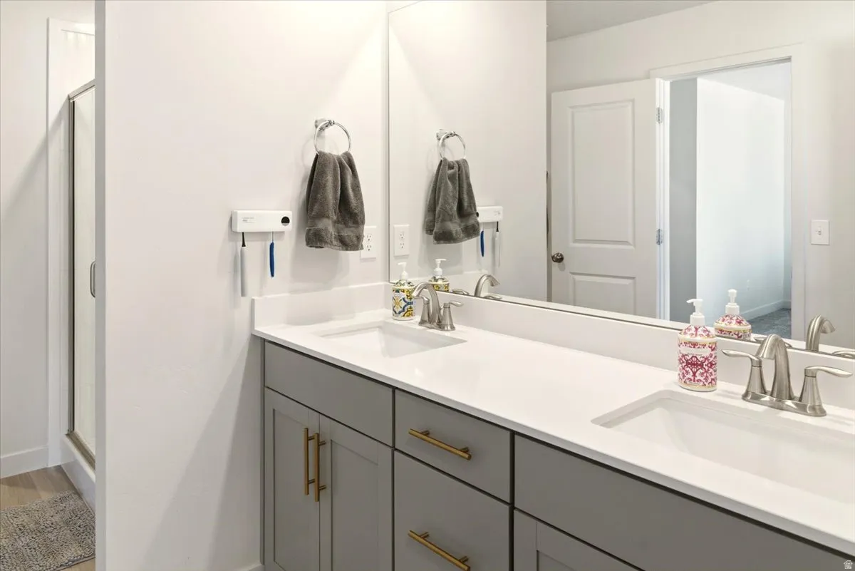 Bathroom with double vanity and a stall shower