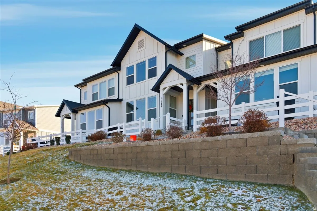 View of front of home with board and batten siding and covered porch