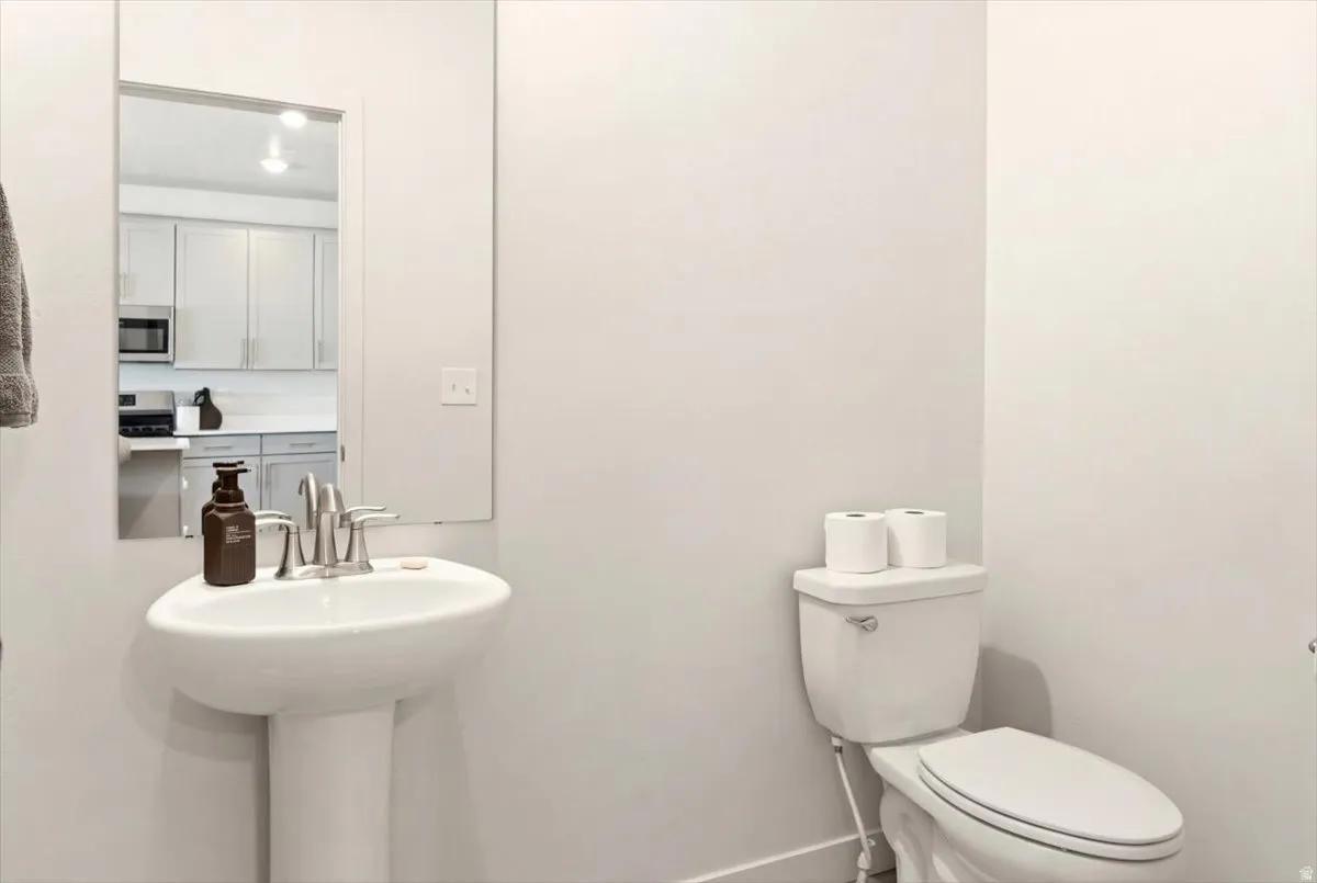 Bathroom featuring toilet and baseboards
