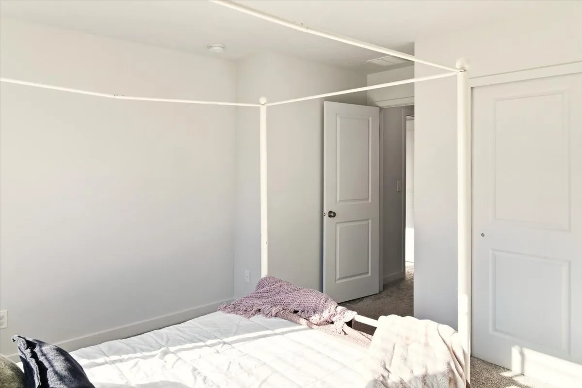 Bedroom featuring dark colored carpet