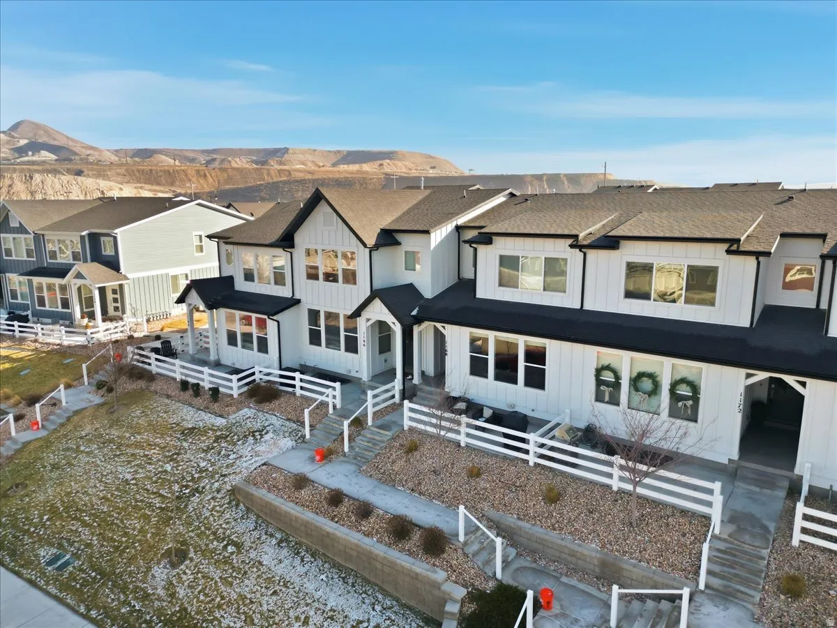 View of front of home featuring a fenced front yard, board and batten siding, a shingled roof, and a residential view