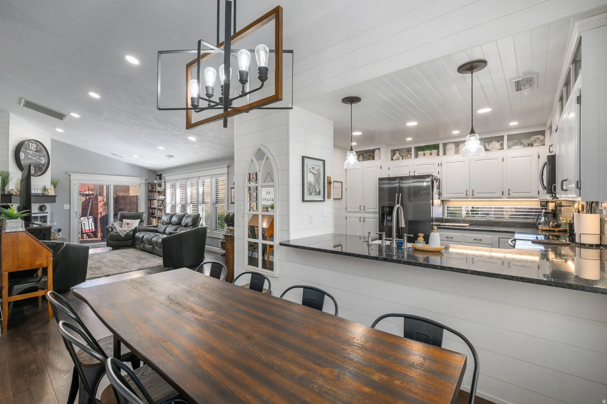 Dining space with recessed lighting, dark wood-style flooring, and lofted ceiling