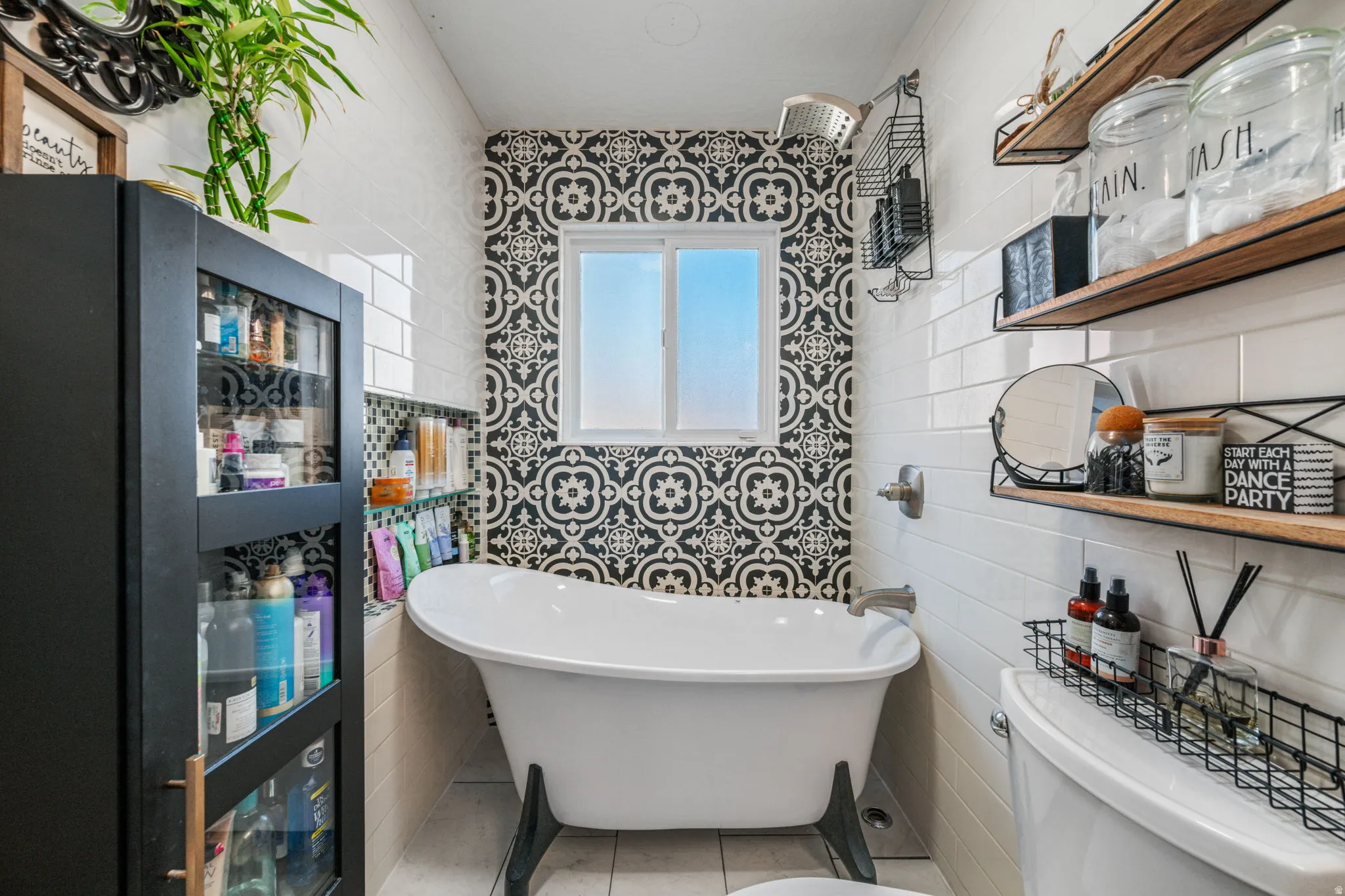 Full bathroom with a soaking tub, tile walls, and tile patterned floors