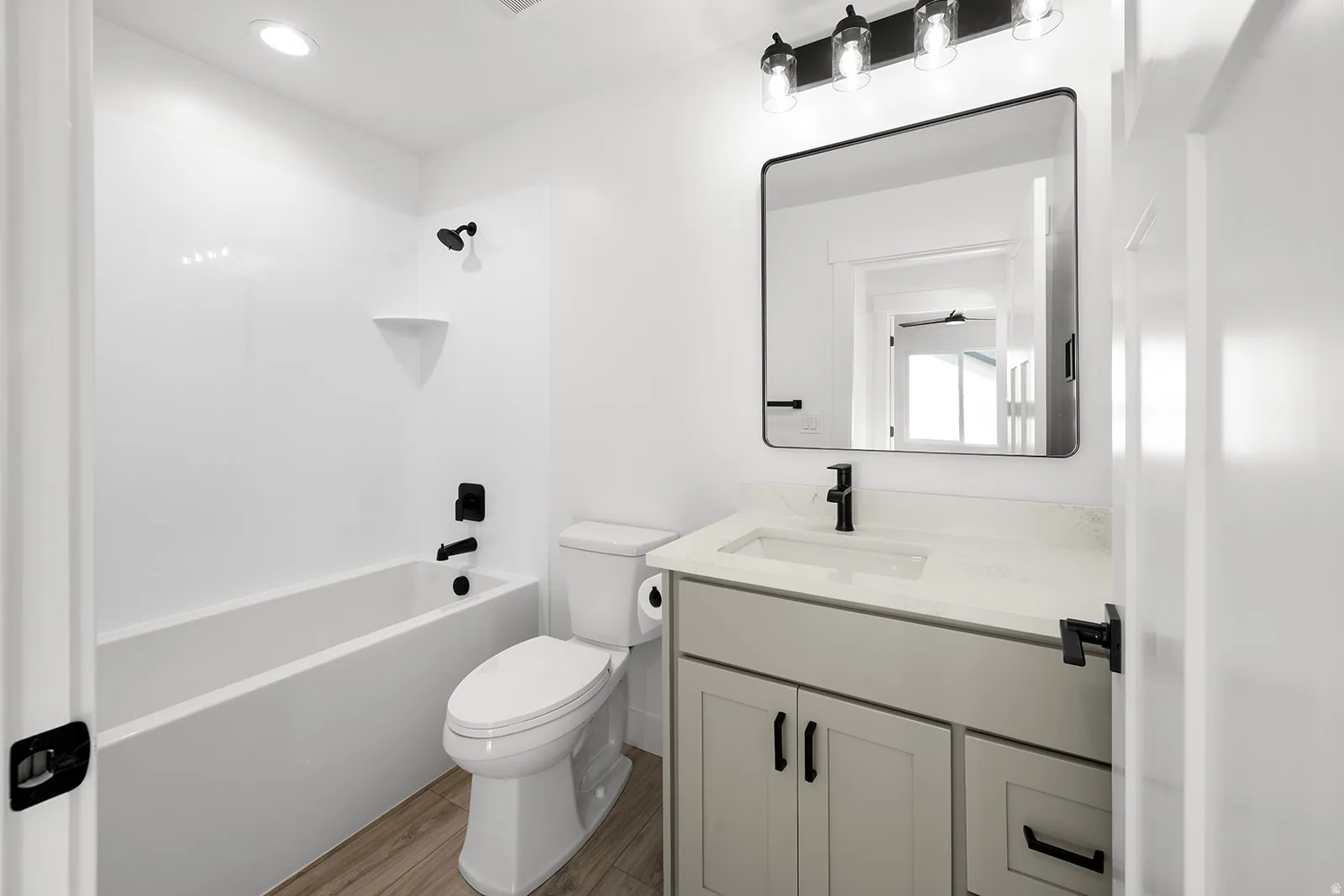 Full bathroom featuring vanity, dark wood-style floors, shower / tub combination, and recessed lighting