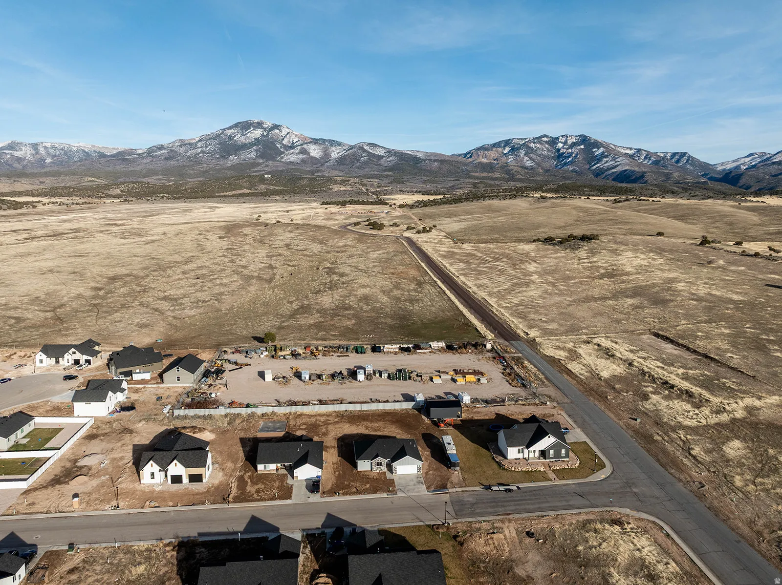Overview of rural landscape with nearby suburban area and mountains