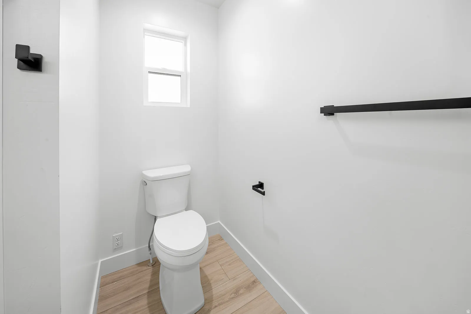 Bathroom with baseboards and light wood-style floors