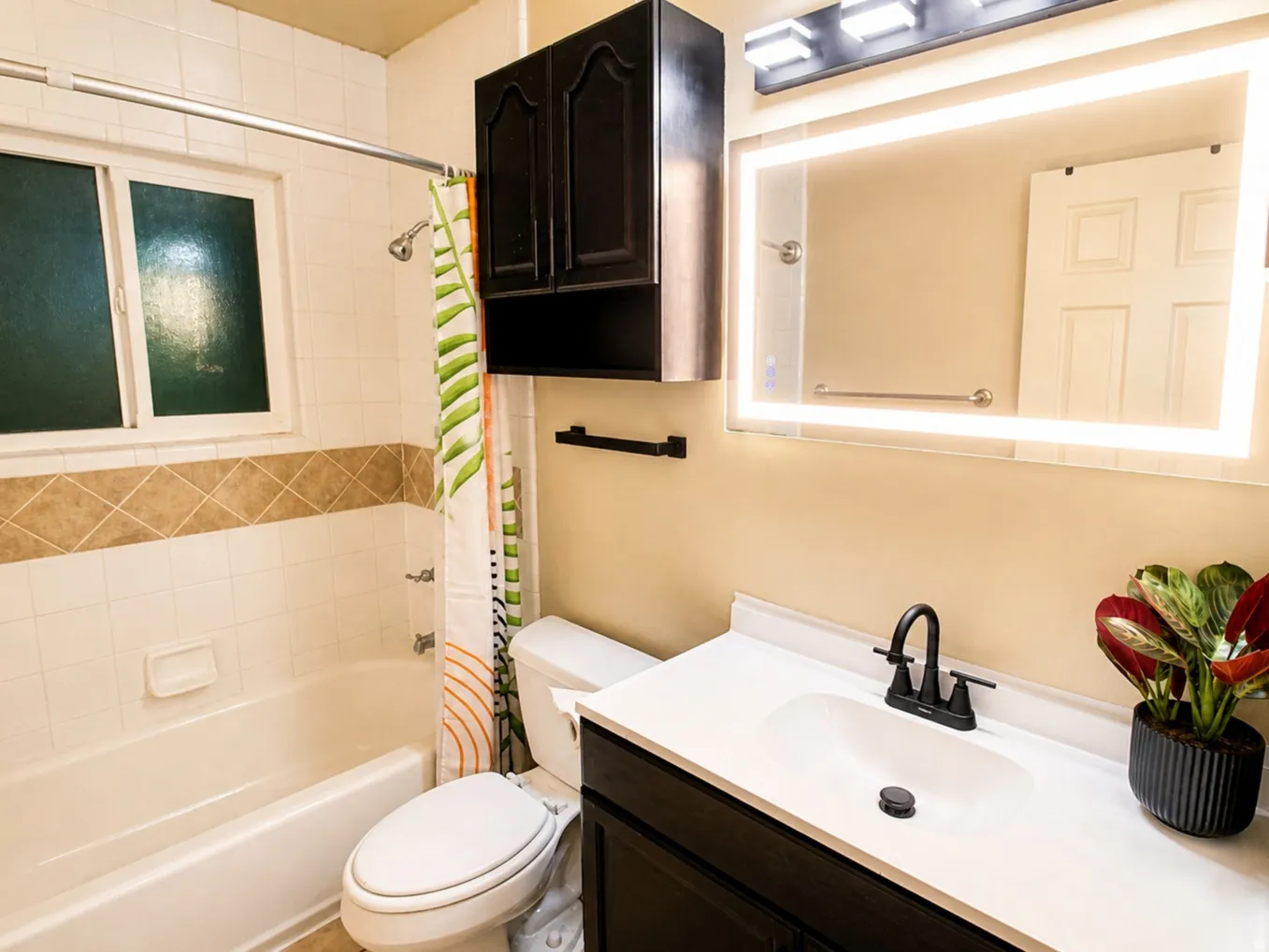 Bathroom featuring vanity and shower / tub combo with curtain