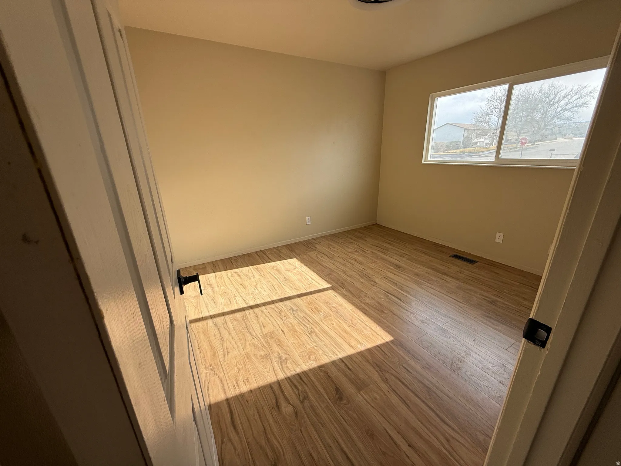 Unfurnished bedroom with wood finished floors