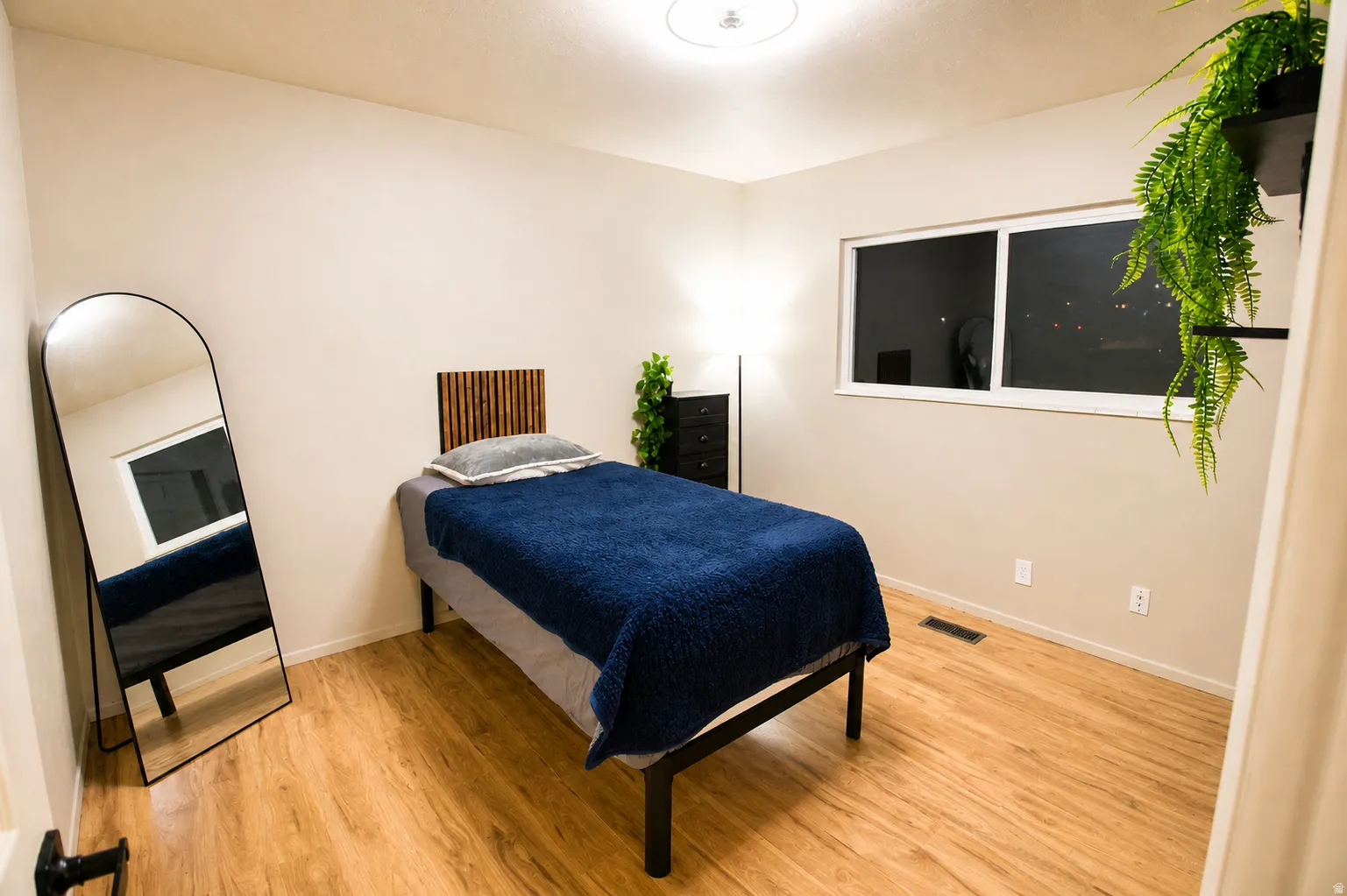 Bedroom featuring light wood-style flooring and baseboards