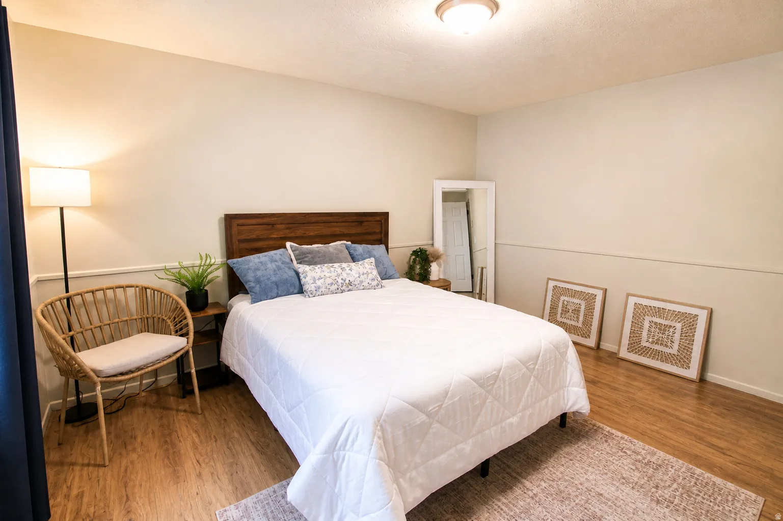 Bedroom featuring wood finished floors and a textured ceiling