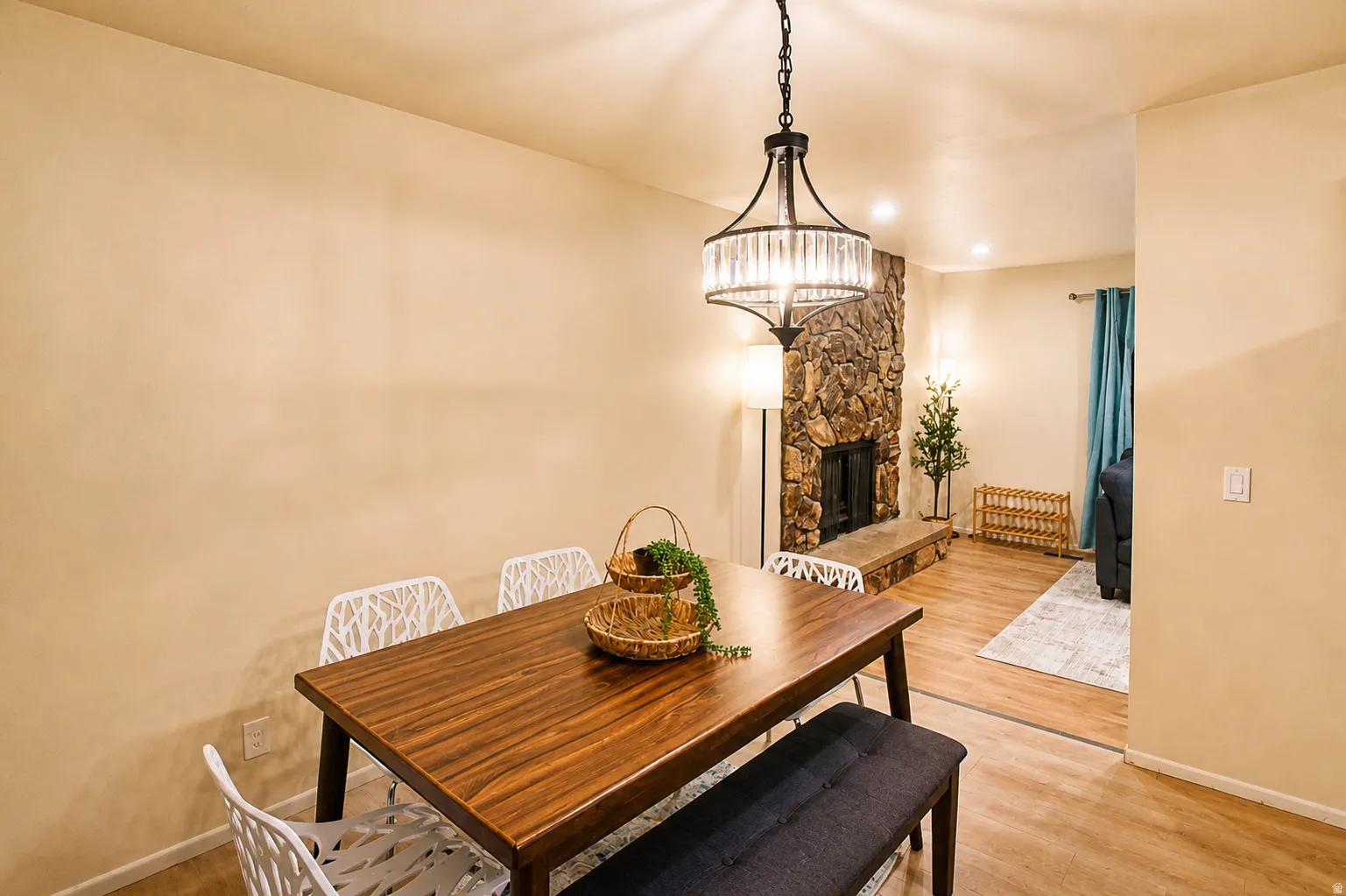Dining room featuring light wood-type flooring, a fireplace, and recessed lighting