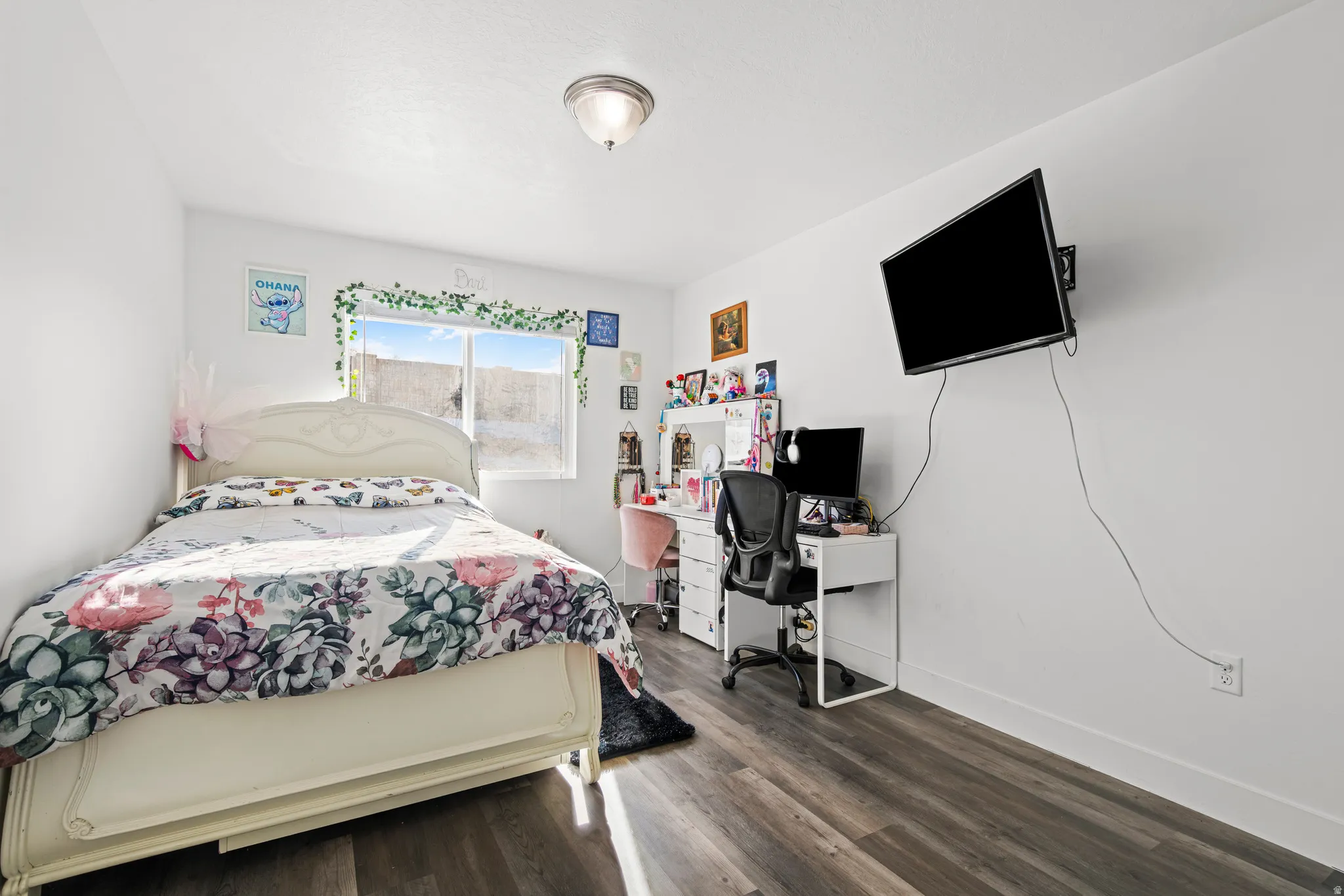 Bedroom featuring wood finished floors and an office area