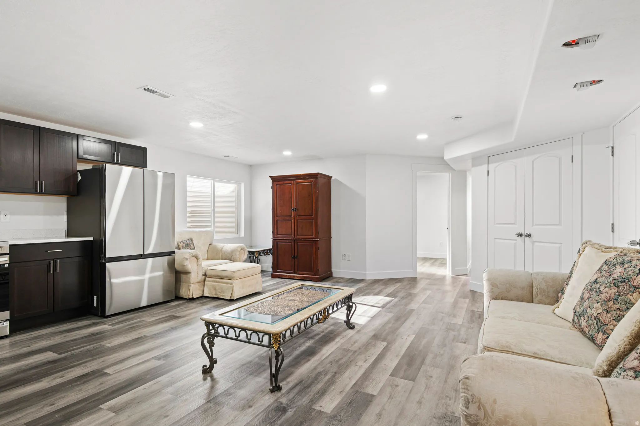 Living room with recessed lighting and light wood-style floors