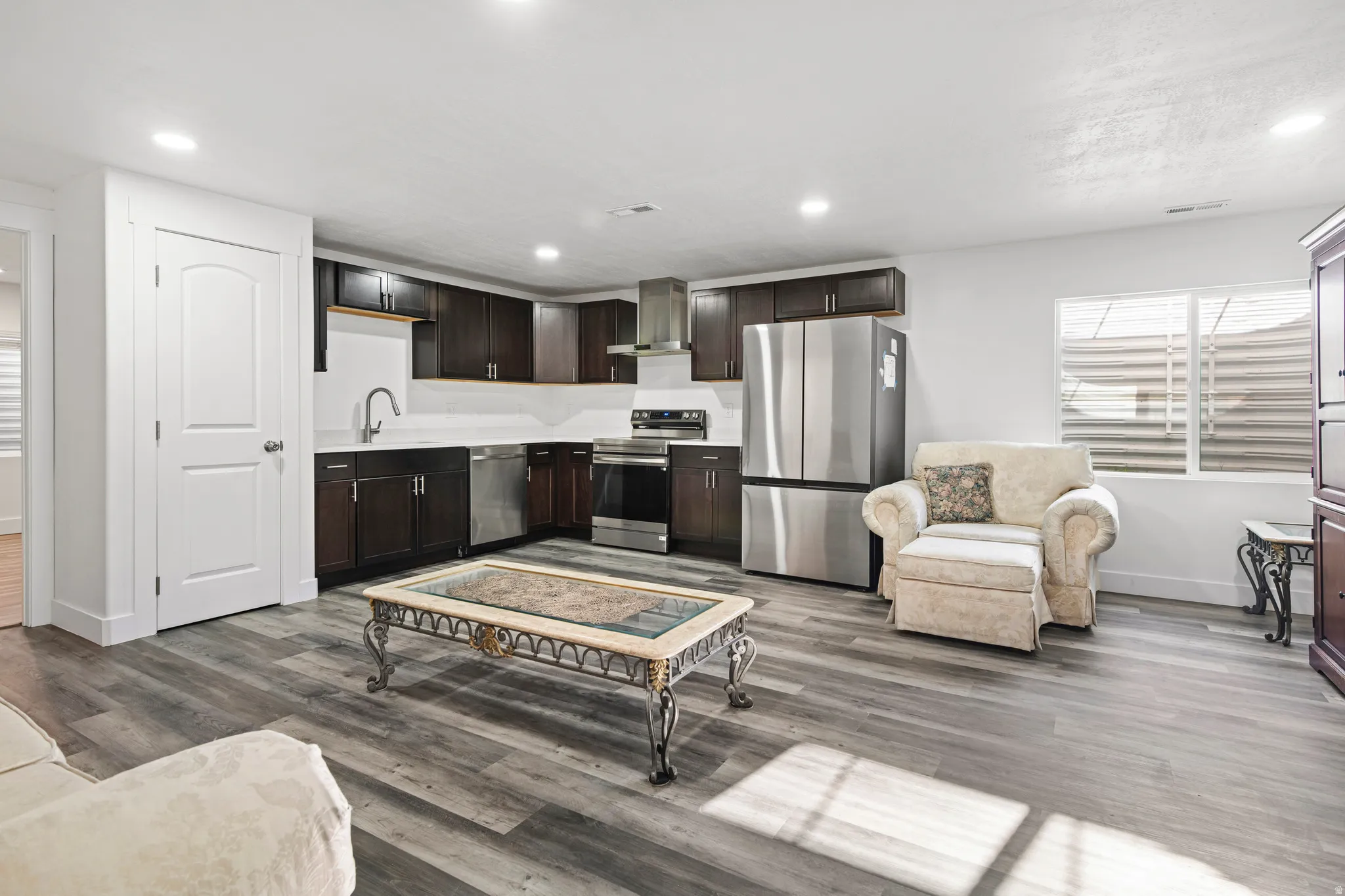 Living room featuring recessed lighting and dark wood-type flooring