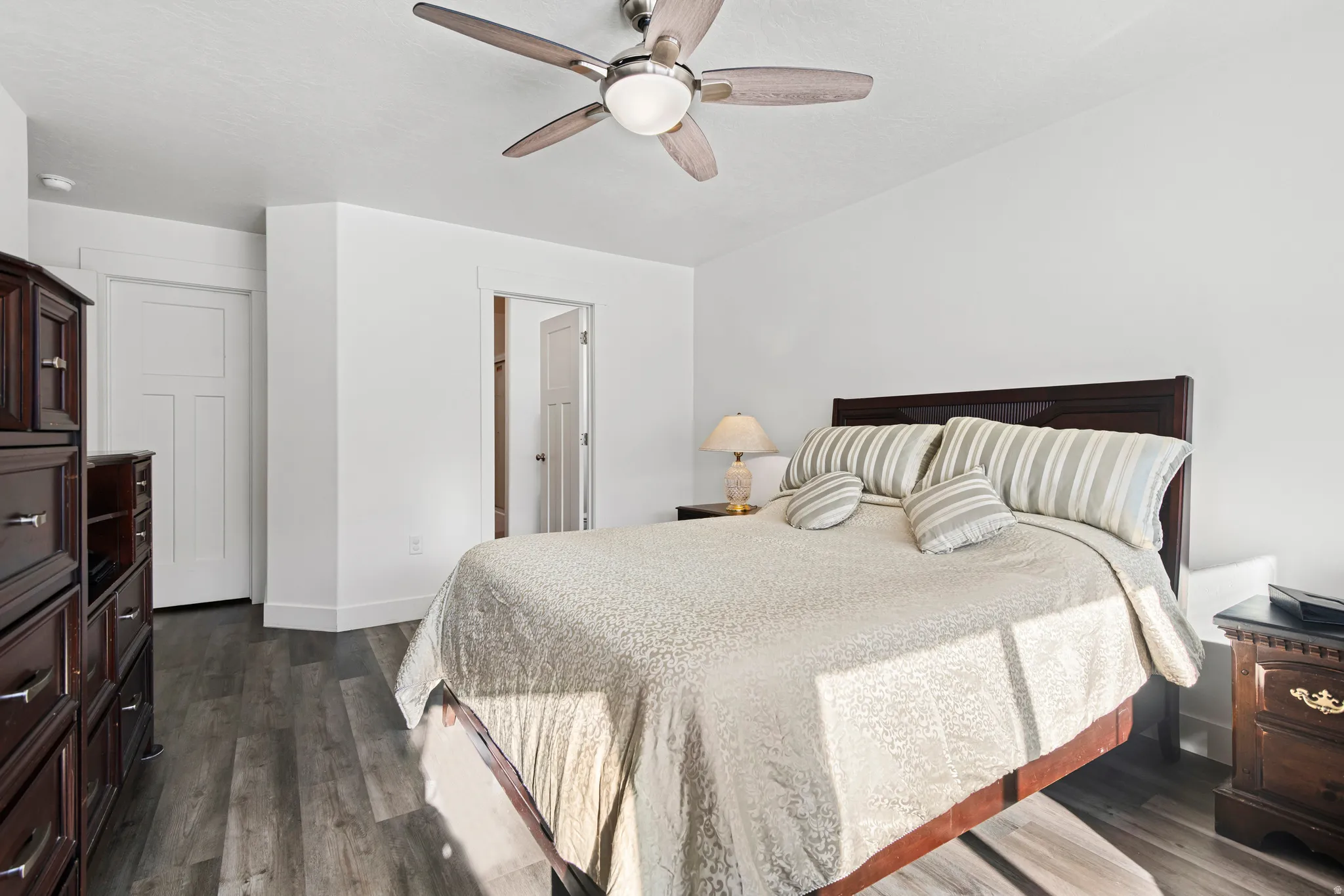 Bedroom with dark wood-style floors and ceiling fan