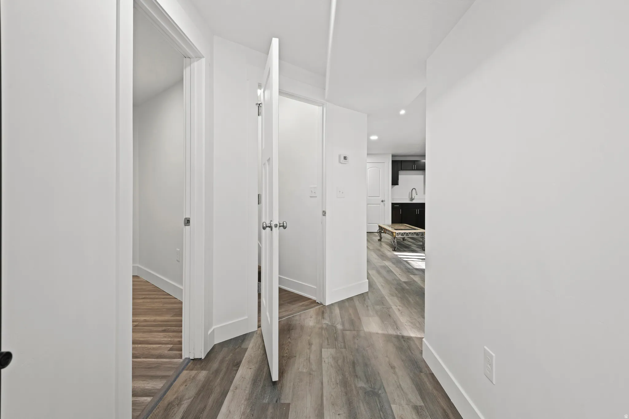 Corridor with recessed lighting and dark wood-style floors