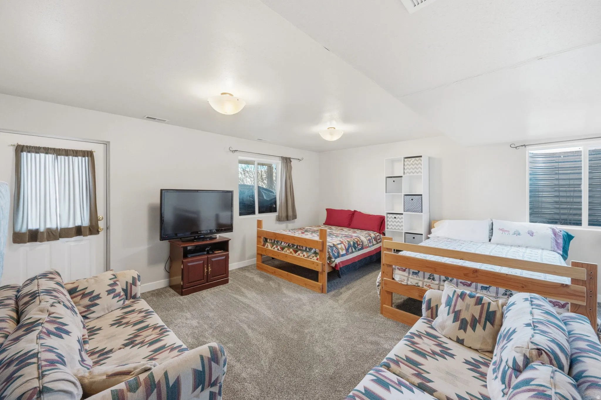 Bedroom featuring light carpet and baseboards