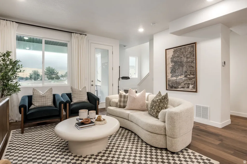 Living room featuring plenty of natural light, recessed lighting, and dark wood-type flooring