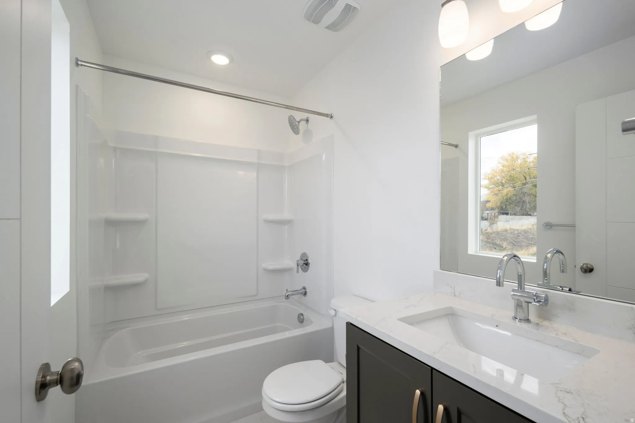 Bathroom with vanity and  shower combination
