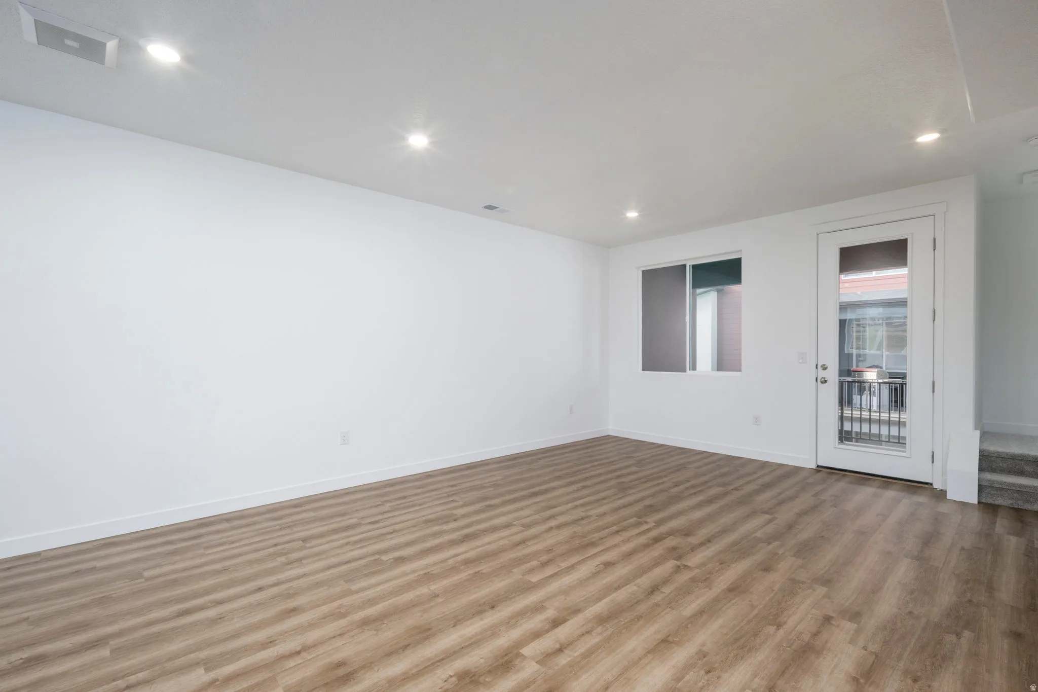 Unfurnished room with light wood-type flooring and recessed lighting